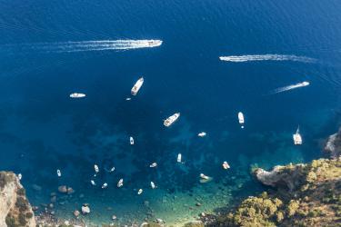 Amalfi Coast -aerial-view-of-boats-moving-on-sea-by-mountain